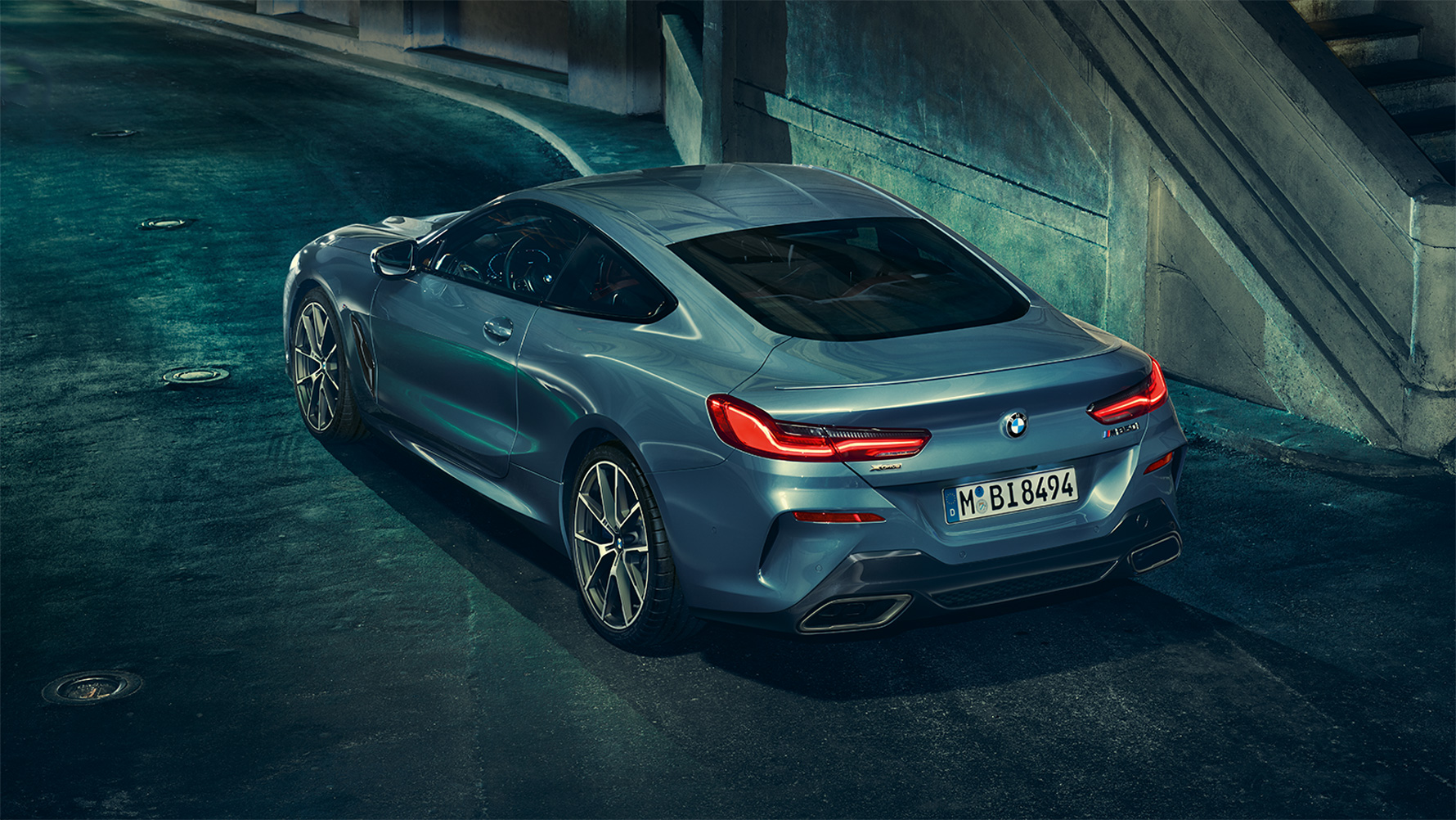 BMW radu 8 Coupé, zadobočný pohľad Zadobočný pohľad na BMW radu 8 Coupé v nočnom mestskom prostredí.