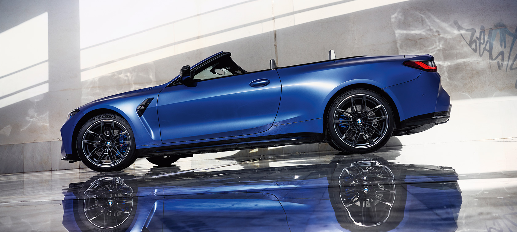 BMW M4 Competition Cabrio s pohonom M xDrive G83 2021 bočný statický pohľad zdola BMW M4 Competition Cabrio s pohonom M xDrive G83 2021 BMW Individual metalíza Frozen Portimao Blue bočný pohľad statický zdola