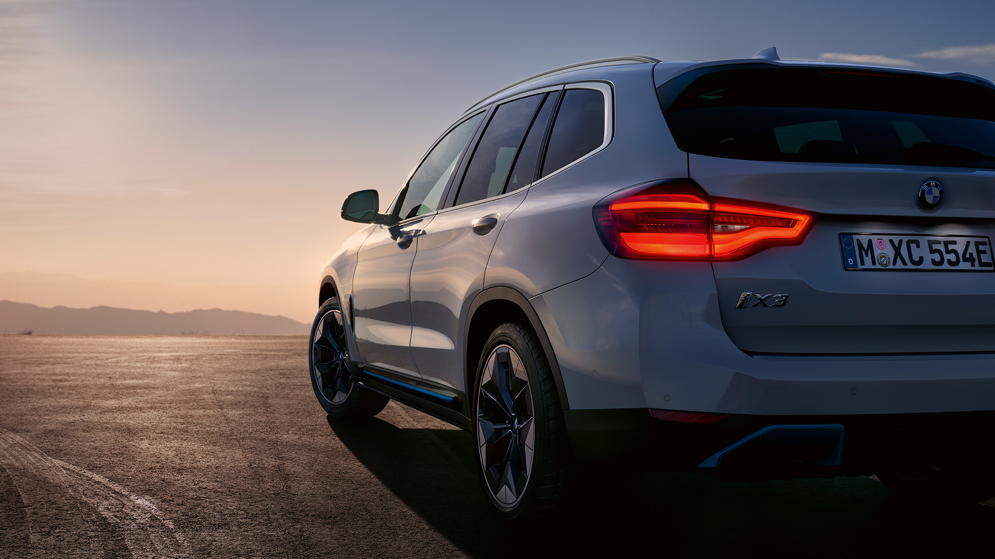 BMW iX3 G08 zadobočný pohľad na ceste BMW iX3 G08 2020 metalíza Mineral White zadobočný pohľad na ceste