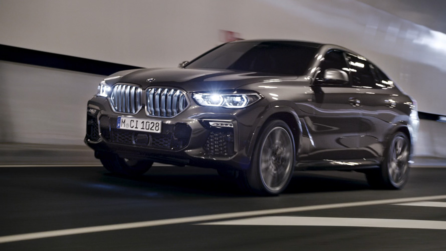Predobočný pohľad BMW X6 G06 2019 BMW X6 G06 2019 predobočný pohľad jazda pred mestským pozadím