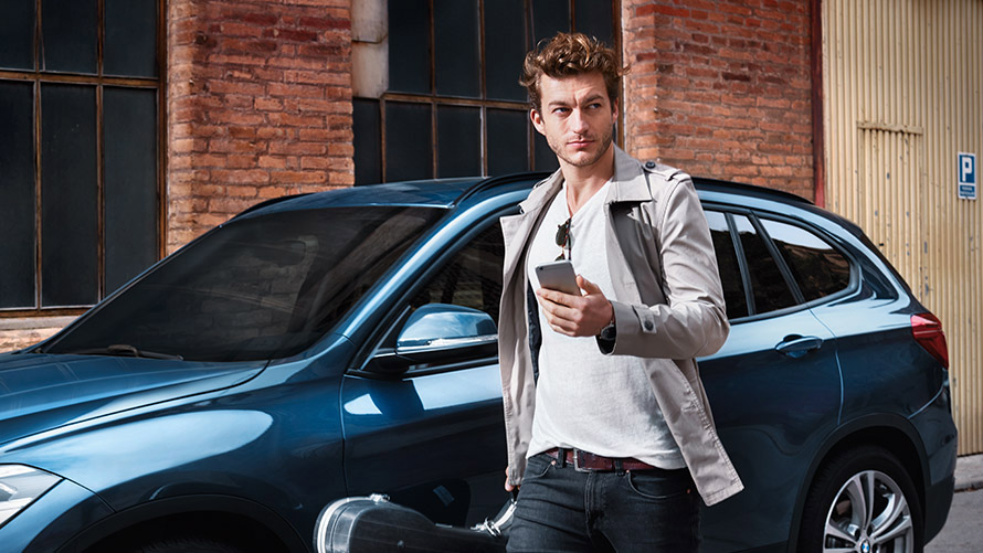 Navigate Door-to-Door Mladý muž kráča po meste a využíva pri tom Navigate Door-to-Door na svojom smartfóne
